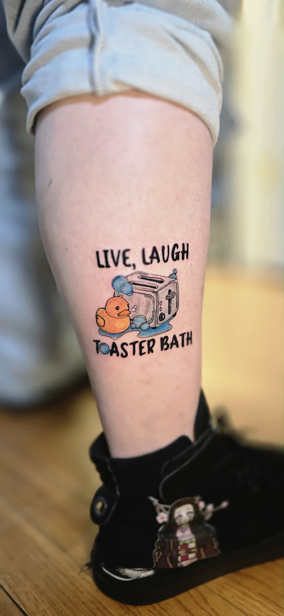 Live Laugh Toaster Bath tattoo on leg