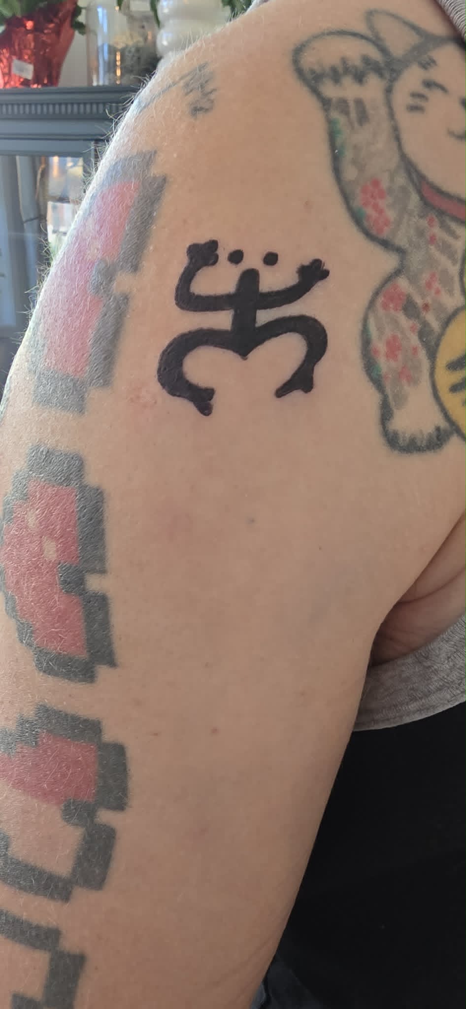 Taino coqui frog symbol tattoo