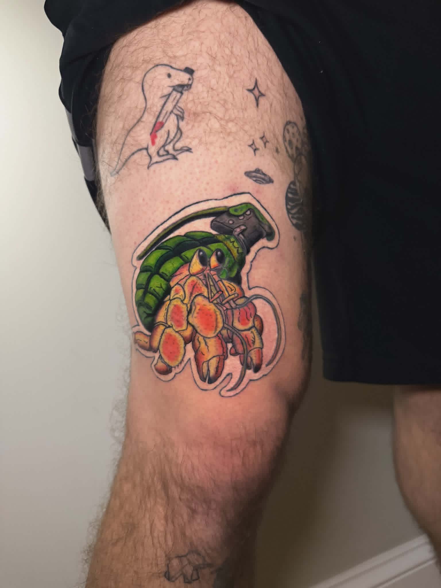 Neo-traditional hermit crab grenade tattoo