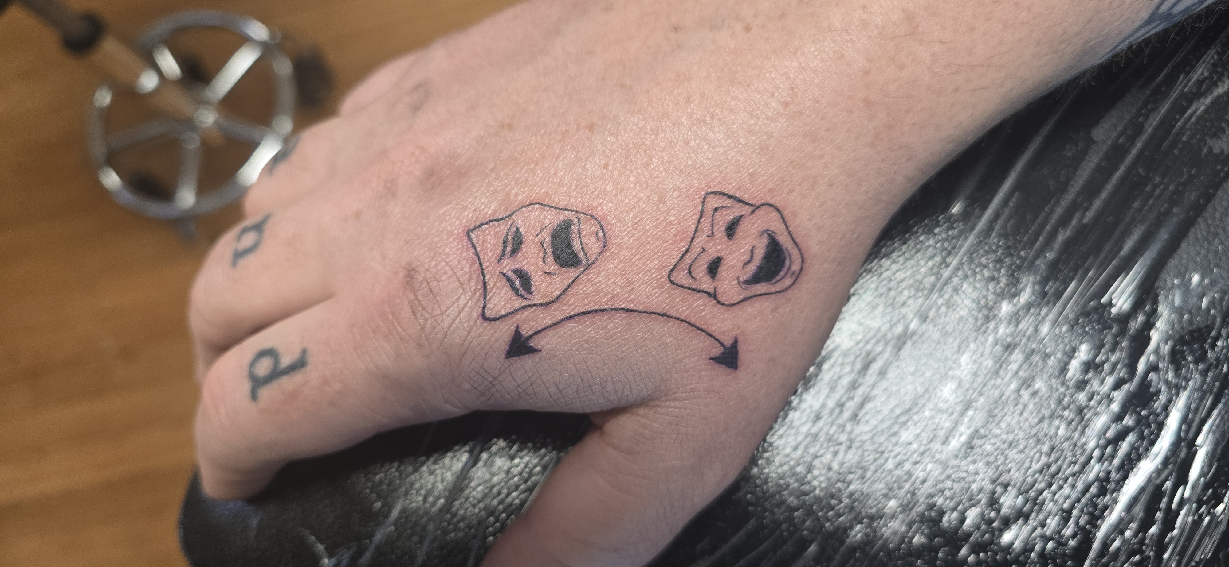 Black and grey tattoo with UV ink accents